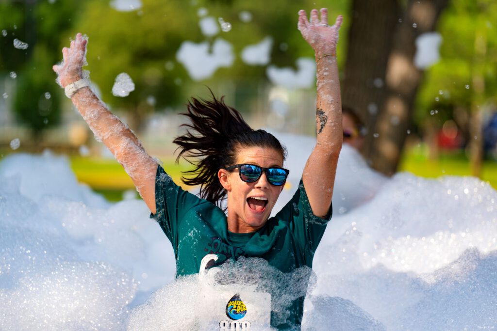 Woman Running Through Foam Bubbles